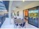 Covered patio with seating area and table, overlooking the pool at 6115 High Seas Dr, Orlando, FL 32821