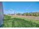 Landscaped backyard with grassy area next to the pool at 6115 High Seas Dr, Orlando, FL 32821