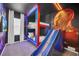 bedroom with bunk beds, slide, and superhero mural at 6115 High Seas Dr, Orlando, FL 32821