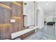 Modern entryway with a wood feature wall, a large mirror and sleek console table at 6115 High Seas Dr, Orlando, FL 32821