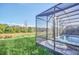 Screened pool and spa with lush green backyard view at 6115 High Seas Dr, Orlando, FL 32821