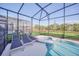 Relaxing screened pool and spa with lounge chairs at 6115 High Seas Dr, Orlando, FL 32821