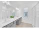 Bathroom with gray vanity, double sinks, and large mirror at 6115 High Seas Dr, Orlando, FL 32821