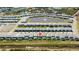 Aerial view of a community with houses, pools, and a pond at 6115 High Seas Dr, Orlando, FL 32821
