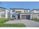 Modern two-story home with attached garage and landscaping at 6115 High Seas Dr, Orlando, FL 32821
