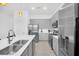 Modern kitchen with stainless steel appliances and white countertops at 6115 High Seas Dr, Orlando, FL 32821