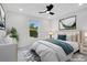 Virtually staged bedroom with a ceiling fan and large window at 1334 Salisbury Dr, Winter Haven, FL 33881