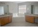 Large bathroom with double sinks and a corner tub at 2887 Sweetspire Cir, Kissimmee, FL 34746