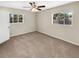Well-lit bedroom with carpet and two windows at 326 Banyan Dr, Maitland, FL 32751