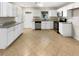 Kitchen with white cabinets, granite countertops, and stainless steel appliances at 326 Banyan Dr, Maitland, FL 32751
