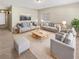 Spacious living room featuring neutral colored couches and a coffee table at 326 Banyan Dr, Maitland, FL 32751