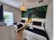 Guest bedroom with two twin beds, a tropical wall mural and plenty of natural light at 8947 Shine Dr, Kissimmee, FL 34747