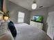 Spacious main bedroom with king-size bed and large TV at 8947 Shine Dr, Kissimmee, FL 34747