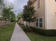 Townhomes in a community with manicured landscaping and walkways at 8947 Shine Dr, Kissimmee, FL 34747