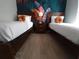 Bedroom with two twin beds and a tropical accent wall at 8947 Shine Dr, Kissimmee, FL 34747