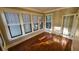Bright sunroom with hardwood floors and multiple windows at 120 S Thornton Ave, Orlando, FL 32801