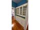 White kitchen cabinets and glass-front hutch offer ample storage at 120 S Thornton Ave, Orlando, FL 32801