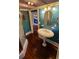 Charming bathroom with pedestal sink, shower, and dark wood floors at 120 S Thornton Ave, Orlando, FL 32801