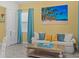Living room featuring a comfy sofa, large artwork, and coastal decor at 3054 Pirate Way, Kissimmee, FL 34747