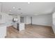 Open living area with wood-look floors and kitchen views at 3606 Walking Stick Way, Poinciana, FL 34759