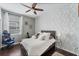 Bedroom with a bed, gaming chair, and leaf patterned wall at 3466 Halsway Dr, Orlando, FL 32824