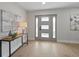 Light and bright entryway with gray walls and wood floors at 2612 Lafayette Ave, Winter Park, FL 32789