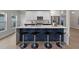 Modern kitchen island with a white quartz countertop and navy blue cabinetry at 2612 Lafayette Ave, Winter Park, FL 32789