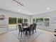 Bright dining room with a wooden table and six chairs, and large windows providing natural light at 2612 Lafayette Ave, Winter Park, FL 32789