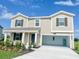 Two-story home with two-car garage and landscaping at 4499 Magnolia Ridge Ct, Kissimmee, FL 34746