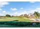 Golf course view with residential homes visible in the distance at 7593 Gathering Dr # 505, Reunion, FL 34747
