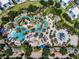 Resort-style pool with multiple pools, a waterslide, and plenty of lounge chairs at 7593 Gathering Dr # 505, Reunion, FL 34747