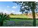 View of golf course with homes in the background at 7593 Gathering Dr # 505, Reunion, FL 34747