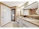 Double vanity bathroom with granite countertop and a walk-in shower at 7593 Gathering Dr # 505, Reunion, FL 34747