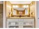 Elegant bathroom with double vanity, granite countertop, and large mirror at 7593 Gathering Dr # 505, Reunion, FL 34747
