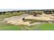 Sand trap on a lush green golf course at 7593 Gathering Dr # 505, Reunion, FL 34747