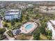 Resort-style pool with lounge chairs and landscaping at 7593 Gathering Dr # 505, Reunion, FL 34747