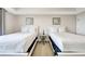 Spacious bedroom featuring two twin beds and a nightstand at 7593 Gathering Dr # 505, Reunion, FL 34747