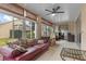 Bright sunroom features comfy seating, ceiling fan, and sliding glass doors at 145 Lewis Dr, Davenport, FL 33837