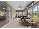 Relaxing sunroom with ample seating and sliding glass doors to backyard at 145 Lewis Dr, Davenport, FL 33837