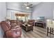 Spacious living room with leather sofas, coffee table and hardwood floors at 145 Lewis Dr, Davenport, FL 33837