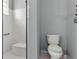 Bathroom with shower, toilet and grab bar at 145 Lewis Dr, Davenport, FL 33837