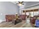 Relaxing living room with leather furniture, hardwood floors, and sunroom access at 145 Lewis Dr, Davenport, FL 33837