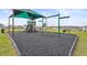 Community playground with shaded play area and swings at 1353 Hanoverian Dr, Lake Alfred, FL 33850