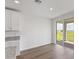 Kitchen and dining area with wood-look floors and patio access at 1353 Hanoverian Dr, Lake Alfred, FL 33850