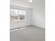 Bright bedroom featuring a large window and grey carpet at 1353 Hanoverian Dr, Lake Alfred, FL 33850
