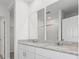 Double vanity bathroom with granite countertops and large mirrors at 1353 Hanoverian Dr, Lake Alfred, FL 33850