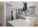 Modern kitchen with gray cabinets and a black range hood at 336 Saint Dunstan Way, Winter Park, FL 32792