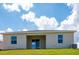 Tan house exterior with a covered patio at 1860 Ross Hammock Ave, Groveland, FL 34736