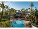 Large resort-style pool with multiple areas, palm trees, and clubhouse at 2909 Calabria Ave, Davenport, FL 33837