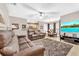 Spacious living room with brown leather couches and a large TV at 5460 E Michigan St # 7, Orlando, FL 32812